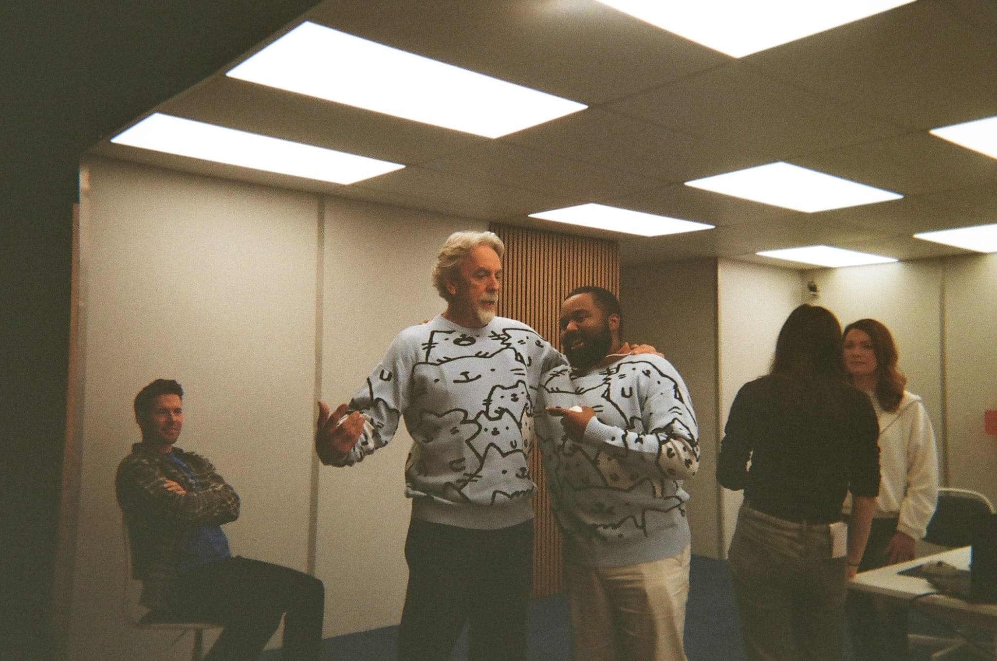 Matching sweaters on set